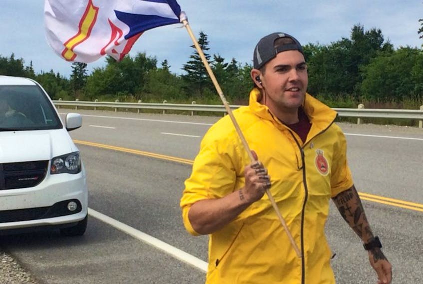 Ordinary Seaman Matt Flynn carries the Newfoundland and Labrador flag while running a leg of Run the Rock 2017 through western Newfoundland. Flynn is one of 16 crew members of the HMCS St. John's navy vessel taking turns running across the island from Port aux Basques to St. John's with a goal of raising $100,000 to grant wishes for 10 kids through the Children's Wish Foundation.