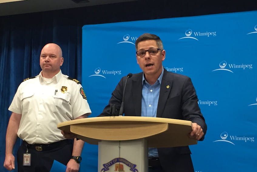 Mayor Brian Bowman (right) and Jason Shaw, the Winnipeg Fire Paramedic Service's assistant chief of emergency management, give an update to the media on the City of Winnipeg’s response to snowfall at City Hall on Sunday. Bowman declared a state of local emergency for the City of Winnipeg.