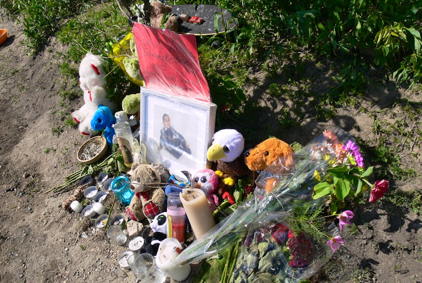 A makeshift memorial is set up on the banks of the Red River in Winnipeg near where nine-year-old Darius Bezecki drowned after falling into the Red River on Friday, July 3, 2020. A vigil was held  on Monday, July 6, 2020, near the spot at Ernie O'Dowda Memorial Park in Elmwood where the boy went into the water. His body was recovered on Sunday, July 5, 2020, after being spotted by a fisherman.