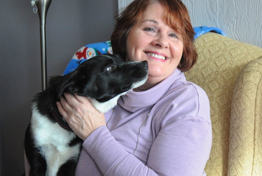 Diann Priddle gets lots of licks from Bear, a dog that was abandoned in Stephenville, which she has adopted.