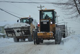 Not everyone had a snow day Monday. Some folks, like these snowplow operators passing each other on Premier Drive, were flat out dealing with the snow.