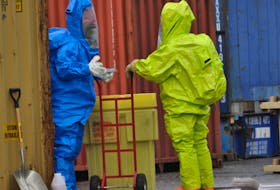 Members of one of the Corner Brook Fire Department's hazmat teams suited up to contain a mock chemical spill during an exercise at the port on Thursday.
