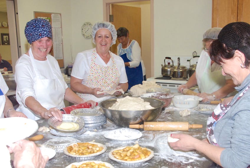 A group of volunteers were in good spirits as they went about making 500 homemade apple pies Tuesday afternoon at The Cathedral of St. John the Evangelist in Corner Brook.