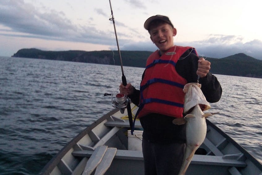 Christopher Park of Cox's Cove reacts to the codfish he reeled in while fishing in the outer Bay of Islands last year.