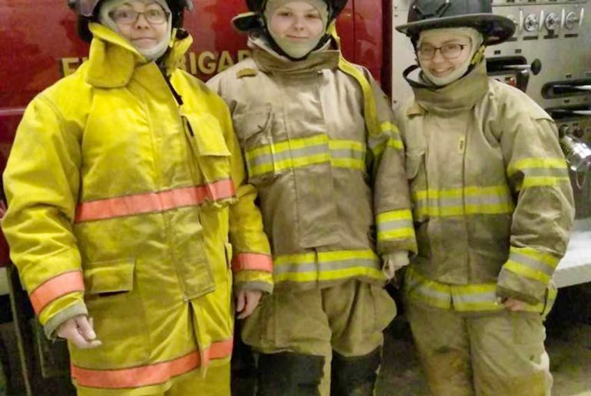 Some of the female firefighters of the Flat Bay-St. Teresa Fire Department pose for a photo near their fire truck including from left: Trina Bennett, Stephanie Legge and Ashlee Hicks.