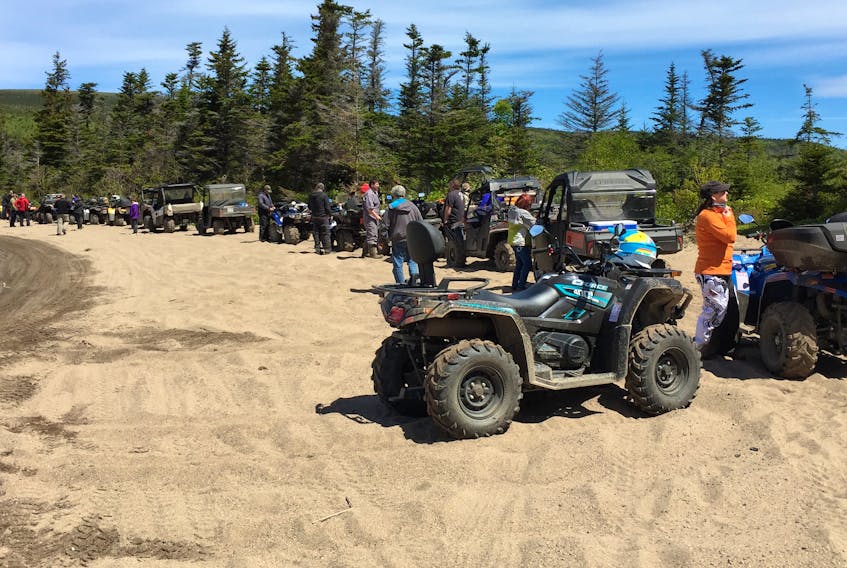 A large group of out-of-province tourists on ATVs enjoy a break on a beach in the Robinsons area of western Newfoundland earlier this summer.