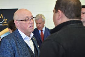 Health Minister John Haggie spoke with Corner Brook Mayor Jim Parsons following an event at Academy Canada on Thursday.