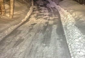 The Cold Brook Road trail being groomed at night by the Bay St. George Snowmobiling Association.