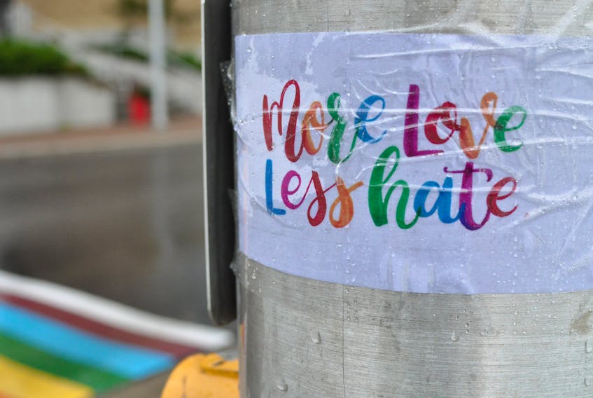 This sign, advocating "More love, less hate," was one of several with the same message taped to the light poles on both sides of the rainbow pride crosswalk outside Corner Brook City Hall sometime Wednesday. The signs are likely in response to the dash cam video that sparked heated debates on Facebook recently of a man who appeared to spit intentionally on the crosswalk on his way across the road.