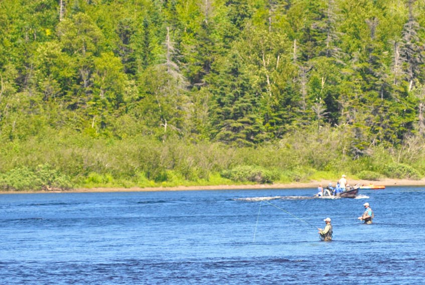 Salmon fishers are seen the Humber River in Steady Brook in this photo from July 2017.