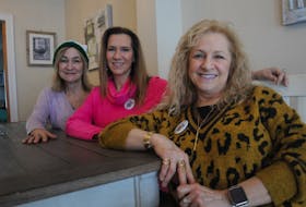 Twin sisters Debbie Caines, left, and Dianne Caines, right, enjoy a visit at the home of their sister, Annette Murphy. The twins, who now reside in Alberta, are back in their hometown to take in as many Corner Brook Winter Carnival experiences as they can.