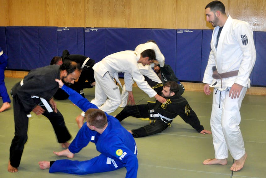 George Alteen, right, observes his students during a training session of the Corner Brook Brazilian Jiu-Jitsu Club at the Vine Place Community Centre on Tuesday night.