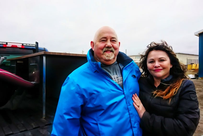With a load of furniture on a pickup truck behind them, Hayward Young, left, chief of the Indian Head Band Council, poses for a photo with Chief Liz LaSaga of the Flat Bay Band Council.