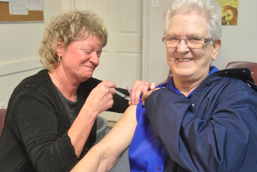 Sabina Power was all smiles as she was getting her influenza vaccine (flu shot) from public health nurse Arleen Quann at the Lions Club in Stephenville on Monday afternoon.