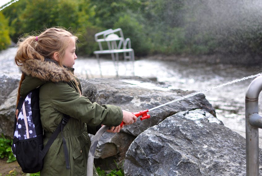 Isabella Devito, a Grade 5 student at J.J. Curling Elementary, got to try out a fire hose like one that would be used to fight forest fires during Explore Forestry Day at Margaret Bowater Park in Corner Brook on Wednesday.
