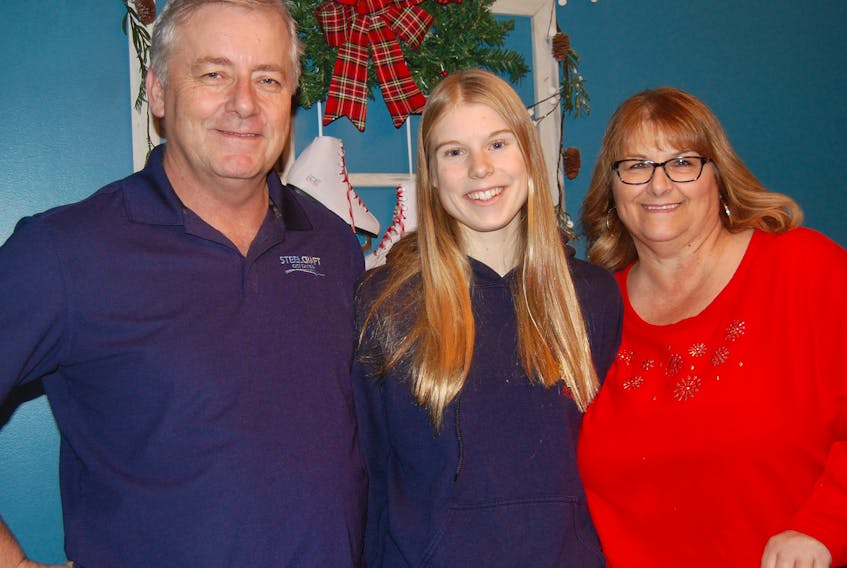 Sara Jordan of Duerstadt, Germany, centre, loves her host parents, Brian and Gertie O’Quinn of Stephenville with whom she is currently spending her first Christmas in Newfoundland. — Frank Gale photo