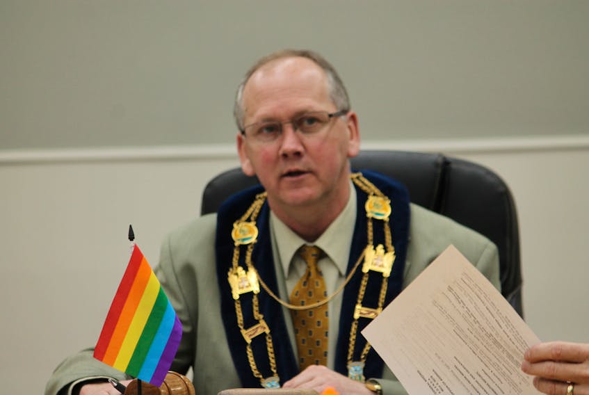 Mayor Tom Rose is seen behind a rainbow flag on the table in council chambers at Stephenville town hall while commenting on rainbow crosswalks that council approved to be painted in the town.