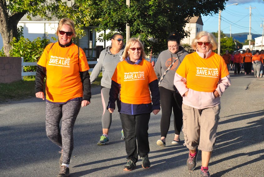 Sporting their orange shirts, three area women lead a World Suicide Prevention Day Awareness Walk in Stephenville including from left: Joannie Coffin, Audrey Barter and Mary Gibbon that had a total of 90 participants.