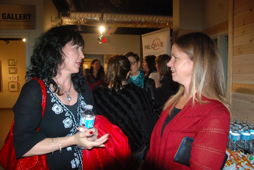 Sherry George of Take the Plunge, left, talks business with Kelly Smith of BDC before the film was shown.