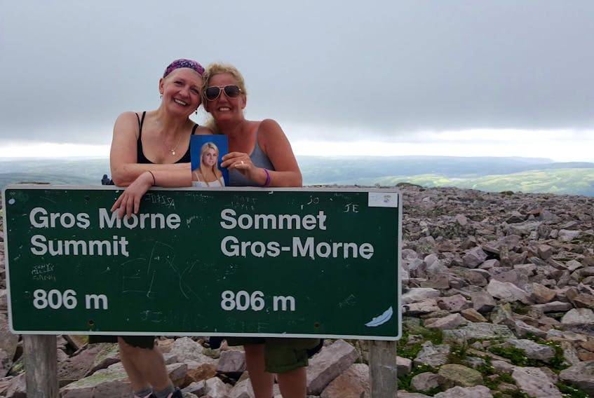 Sherree-Lin Davis, right, of Kelligrews holds a picture of her daughter Alyssa Davis while posing for a photo at the top of Gros Morne with her friend Louise Butler. Alyssa died in a car accident in December 2015 and Sherree-Lin is honouring her by doing things that the teen had on her bucket list.