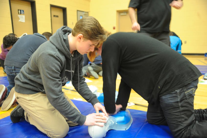 Stephen Webb, left, partnered with Remy Byrne as the Level 2 students received training in CPR and defibrillation from St. John Ambulance at Corner Brook Regional High School Wednesday.