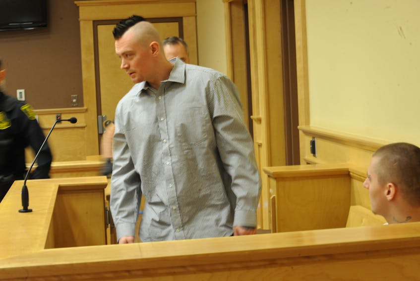 Paxton Sheahan, standing, arrives in court after Dillon Bourgeois has already been seated Thursday morning.