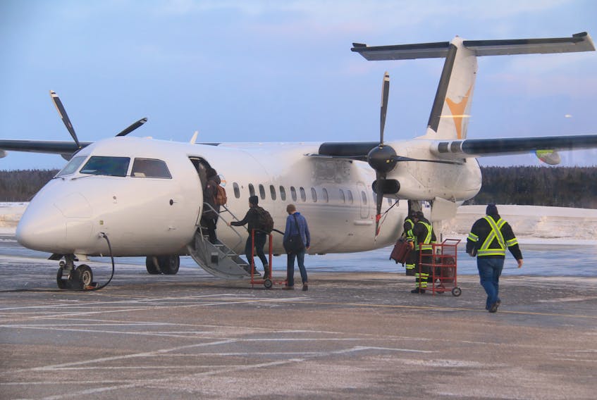 Passengers board a Provincial Airlines flight bound for St. John’s Wednesday morning at the Deer Lake Regional Airport.