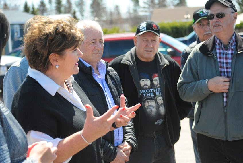 Gudie Hutchings, left, talks with members of the Citizens Outdoor Rights Alliance members who confronted the MP for Long Range Mountains about salmon fishing regulations during her visit to Reidville Thursday.