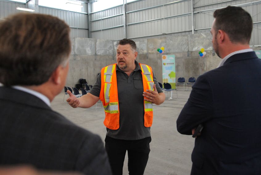 Trent Quinton, chief operations officer with Western Regional Waste Management, leads a tour of the new Wild Cove transfer station for officials attending the official launch of the new Sort-It Western program Tuesday.
