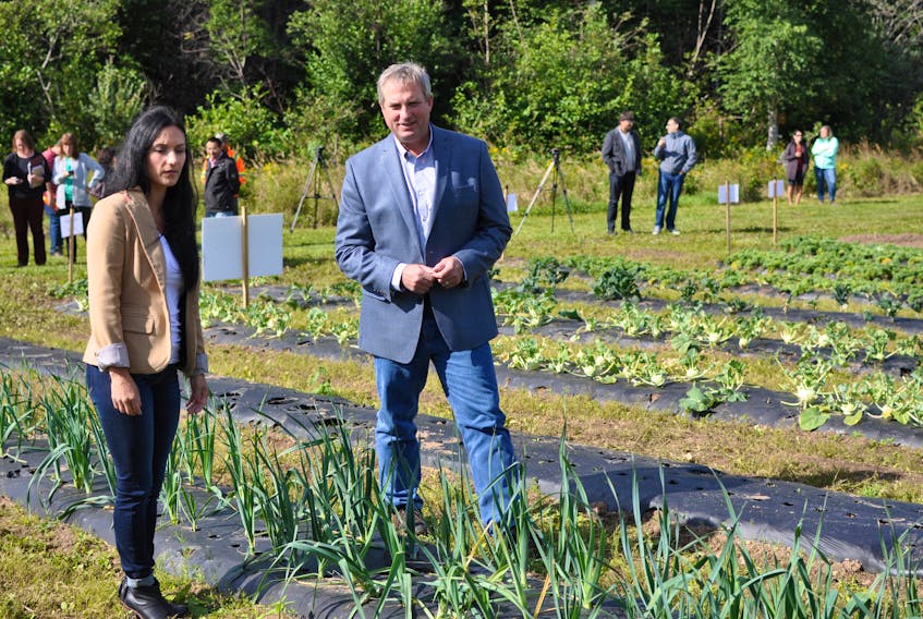 Sabrina Ellsworth, manager of agriculture research with the Agriculture Production and Research Division of Fisheries and Land Resources, talks with Minister Gerry Byrne during a tour of the Western Agriculture Centre: Agriculture Research Station in Pynn's Brook on Monday.
