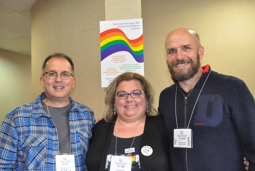 Chantal Drake, centre, one of the participants in an Inclusive Communities Regional Conference, poses for a photo with facilitators Kevin Welbes Godin, left, and Martin Krajcik.