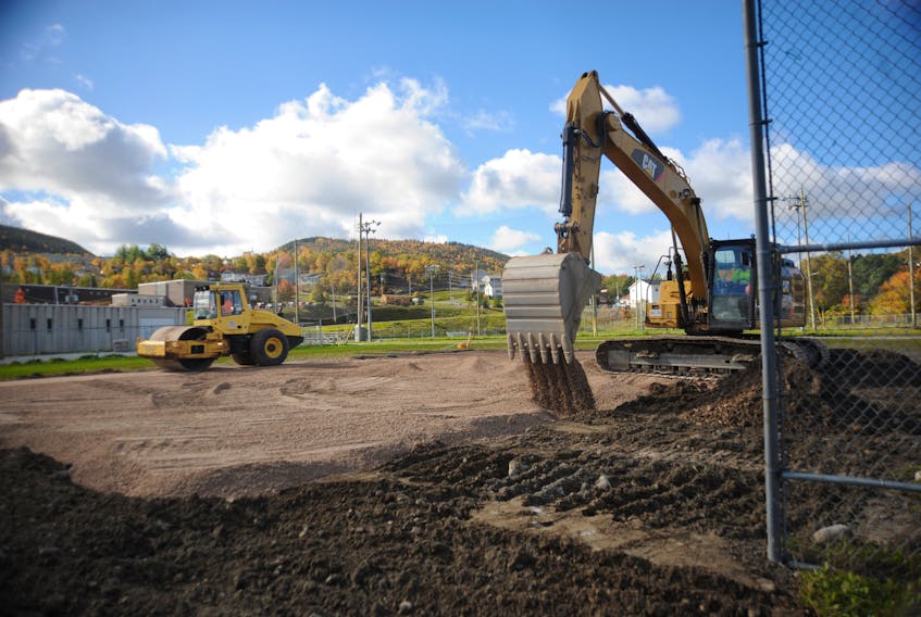 Heavy equipment works on preparing the site at the former B diamond softball pitch on Wellington Street in Corner Brook Wednesday.