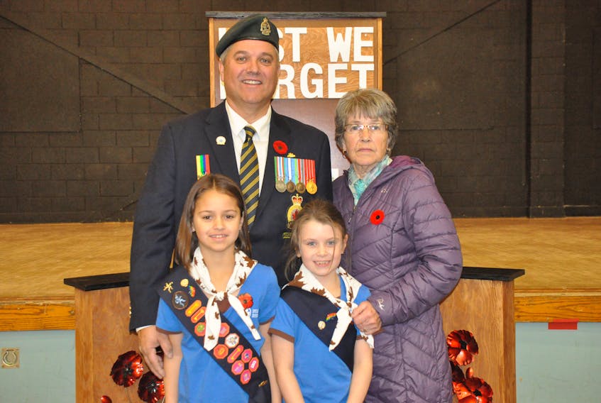 Modern day war veteran Jamey French, back left, stands with his mom Norma French, while posing for a photo with his daughters from left: Jaime French and Maria French following Remembrance Day ceremonies at Stephenville High School on Sunday.