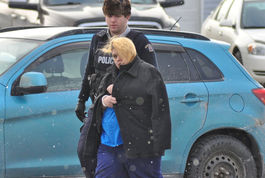 Stacey Young is seen being led into Stephenville Provincial Court by police on Monday afternoon.