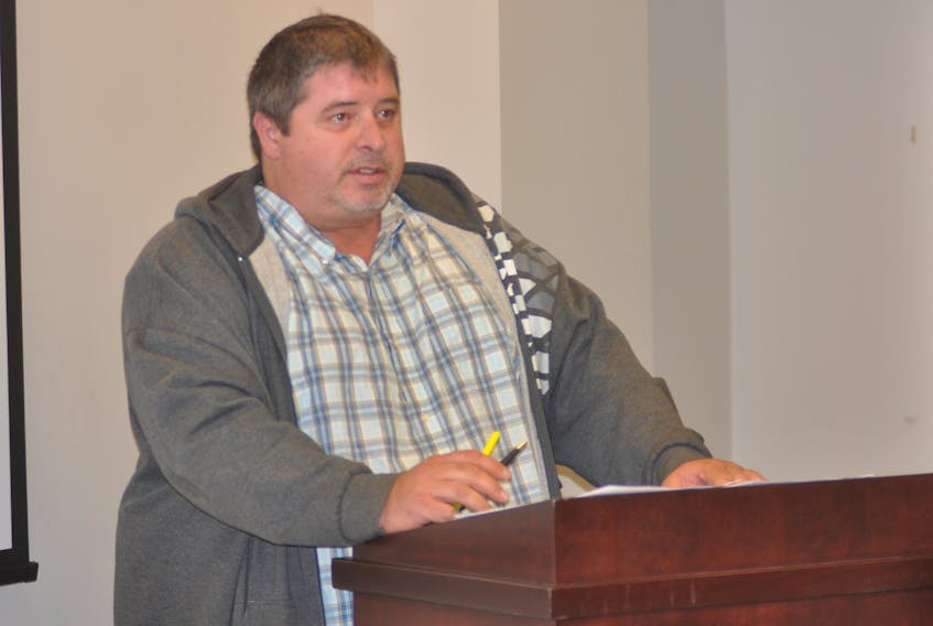 Georgetown Road resident Ross Edison reads a statement during Wednesday night's public hearing at City Hall.