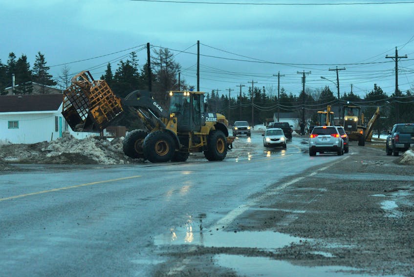 Equipment was busy on Saturday afternoon working to try and ease up some of the flooding along the roadway in Port au Port East, slowing traffic and even stopping it for a short period.