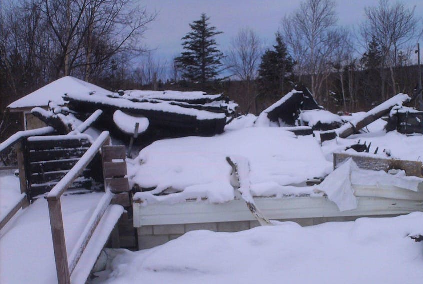 The snow-covered remains of Jim Wall and Bernadette Garnier O’Quinn’s house in Flat Bay Brook is seen in this photo.