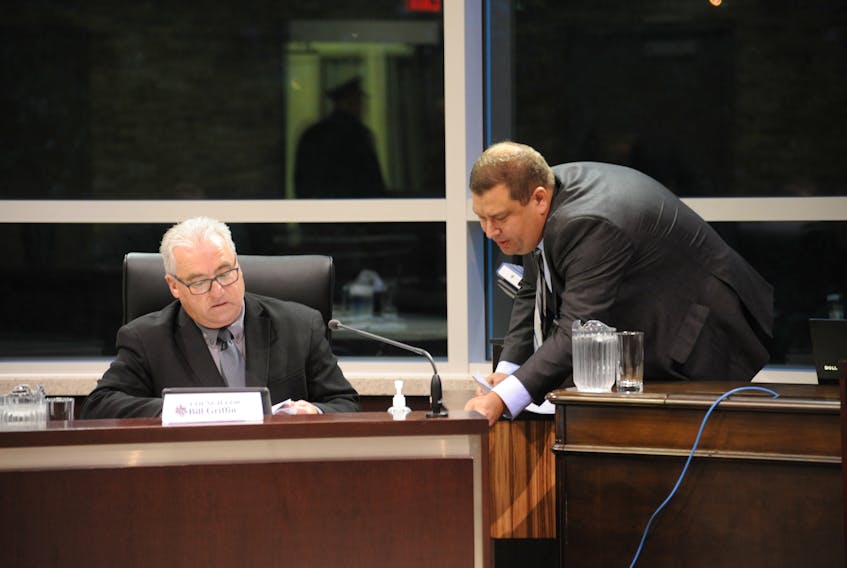 Deputy Mayor Bill Griffin, left, and Mayor Jim Parsons prepare for the Corner Brook city council’s public meeting Monday night.