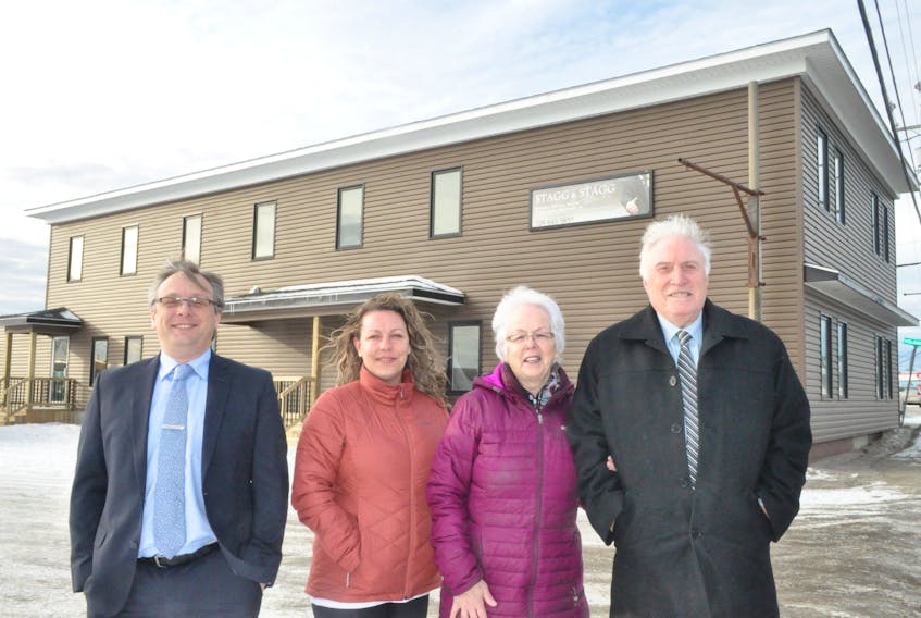 The Staggs, along with their architectural drafter Laurie Flynn, pose for a photo in front of the renovated “Lidstone Building” on Main Street in Stephenville that houses the Stagg and Stagg Law Offices downstairs. From left are: Trevor Stagg, Flynn, Cheryl and Fred Stagg.