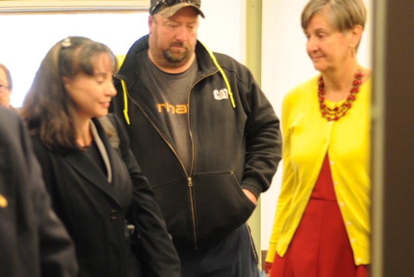 Lori Lee Sharpe, left, the City of Corner Brook's solicitor, chats with, from left, Dave Temple and Pauline Hutchinson, who both live near Country Haven Funeral Home, following the hearing in Deer Lake Thursday of an appeal of the city's denial of the home's plans to add a crematorium.