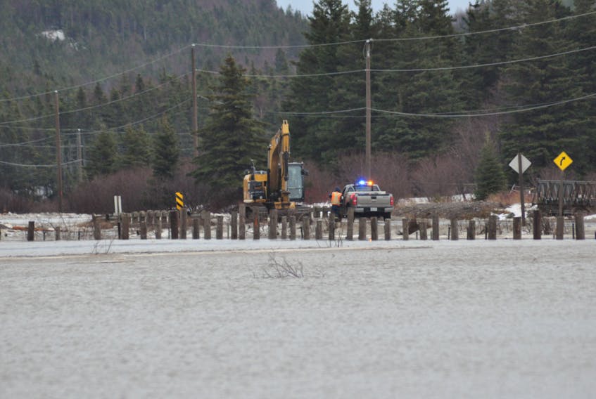 A photo taken during the most recent flooding in Noel's Pond shows an excavator operator with Marine Construction talking with a Transportation and Works official at the bridge in the community.