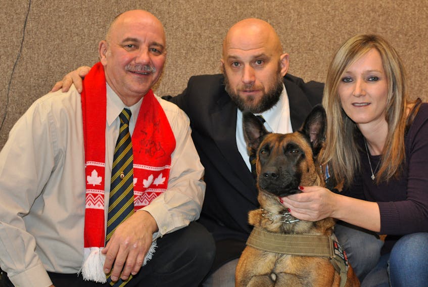 Greg Schroh, left, poses for a photo with Mike Rude, Elaine Kearney and Rude’s service dog Spark after she was made an honorary lifetime member of Branch 13 of the Royal Canadian Legion in Corner Brook on Saturday.