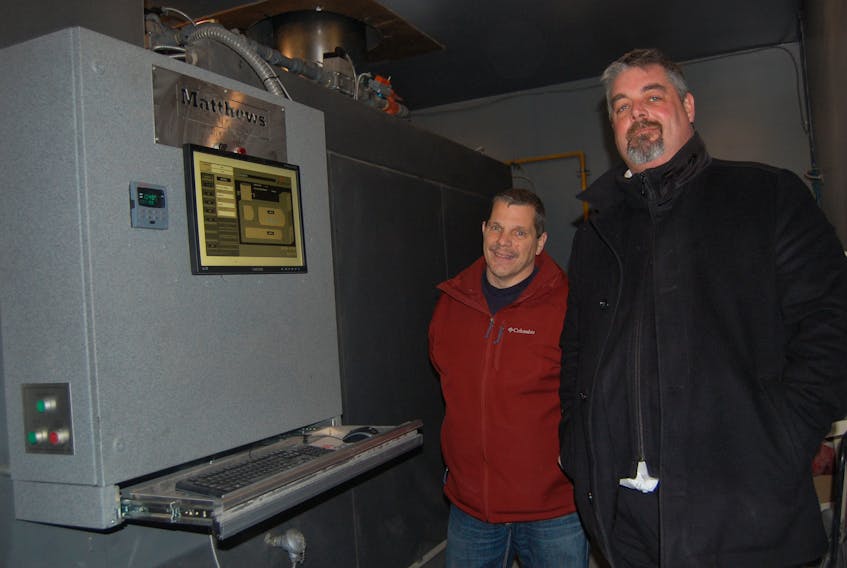 Co-owners of Russell’s Funeral Home in Stephenville: Keith Russell, left, and Dave Mooney, stand next to the retrofitted M-pyre 2.0 crematorium that is completed computerized and monitored from Orlando, Florida, USA.