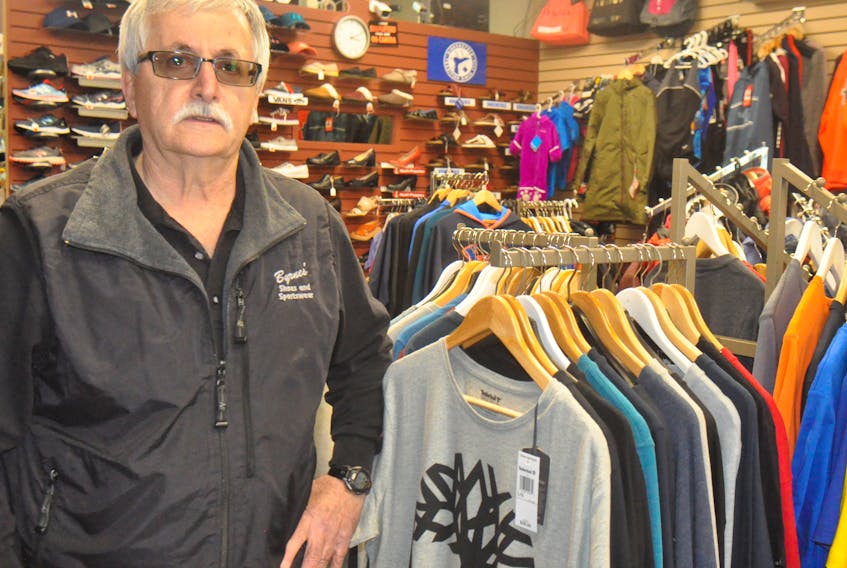 Bob Byrnes, owner-operator of Byrnes Shoes and Sportwear, in his store at 83 Main St., which has received a business Lifetime Achievement Award for the Long Range area.
