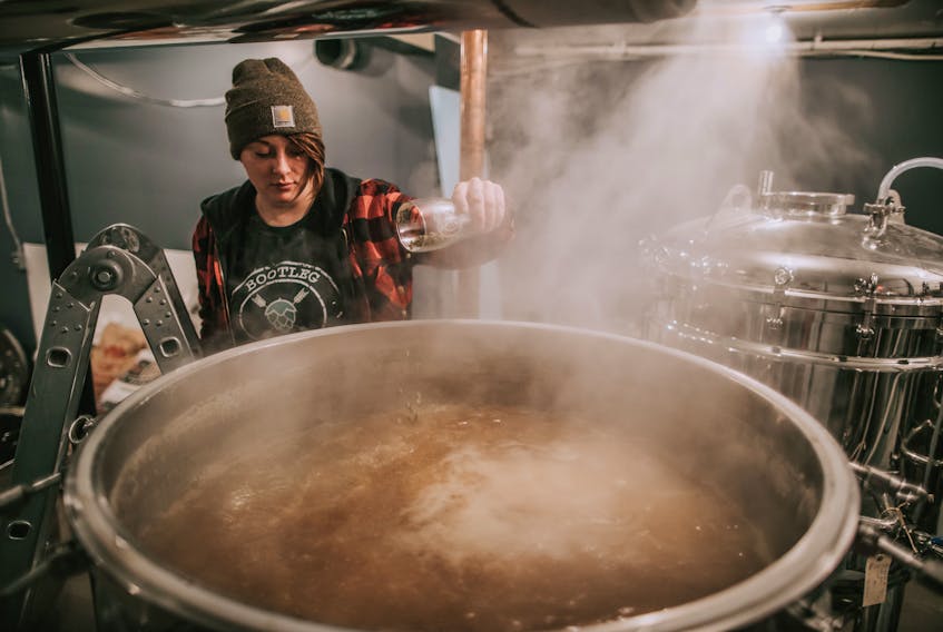 Morgan Turner-Crocker, co-owner of the Bootleg Brew Co. in Corner Brook, is pictured adding a few ingredients to a batch of beer.