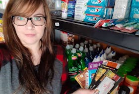 Kayla Pike at home in front of some of the items she got for free or at a reduced price – thanks to using her coupons.