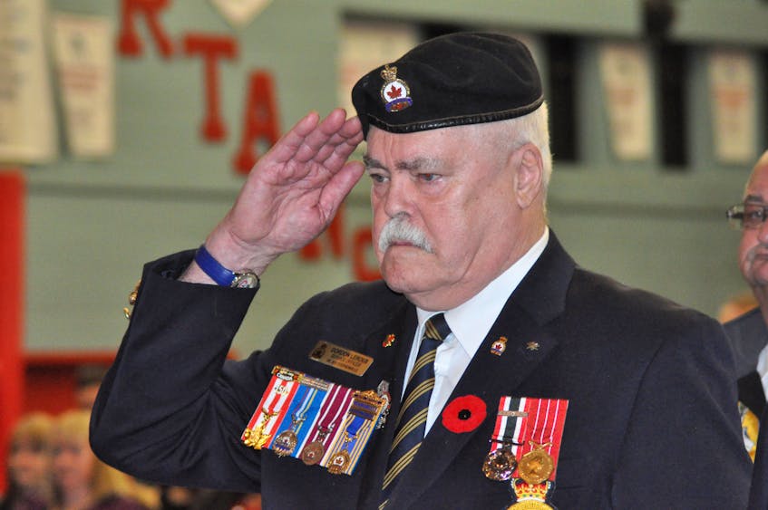 Gordon LeRoux, a former military serviceman and longtime Legionnaire, salutes the playing of the Last Post during Remembrance ceremonies at a Stephenville High School assembly Thursday.