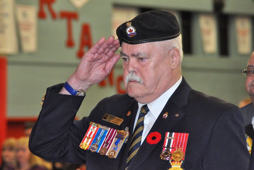 Gordon LeRoux, a former military serviceman and longtime Legionnaire, salutes the playing of the Last Post during Remembrance ceremonies at a Stephenville High School assembly Thursday.