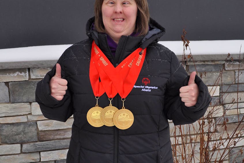 Corner Brook native Nikki King proudly displays her three gold medals from the Special Olympics Alberta Winter Games.