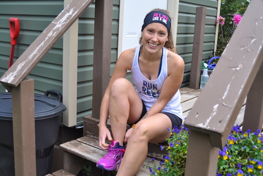 Erica Summers poses for picture as she laces up her sneakers. Summers and some members of the Humber River Runners will be participating in the Fight Like a Girl run in aid of the Canadian Breast Cancer Foundation on Sunday.